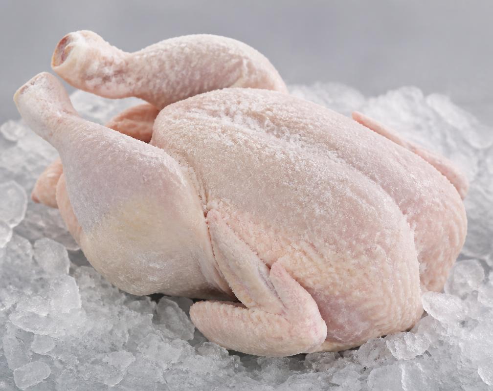 Whole frozen hen without giblets on crushed ice, unbranded product photograph